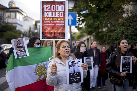 Women members of the Iranian community in Madrid shout and hold signs during a protest in front of the Iranian Embassy in Madrid, protesters demanded an end to the violence and repression by the Islamic Republic regime during protests across Iran.