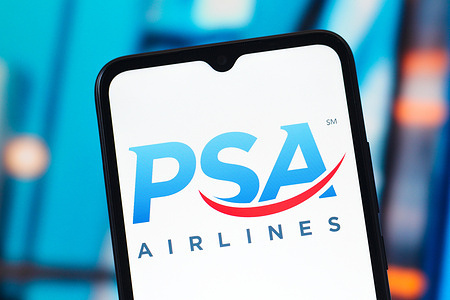 In this photo illustration, the PSA Airlines logo is seen displayed on a smartphone screen.