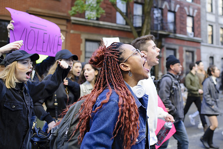 Young men and women take part in an impromptu march through Greenwich Village after a "Love Rally" in Washington Square Park organised in response to Donald Trump's presidential victory to show support for groups victimised over the course of his campaign.