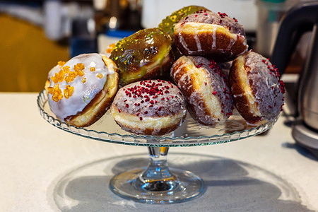A display of doughnuts is seen in a coffee shop. On Feb. 12, Poland celebrates “Tlusty Czwartek,” or Fat Thursday, a Christian tradition marking the last Thursday before Lent, when people across the country enjoy rich, fatty foods. As Lent is a period of fasting, the days leading up to Ash Wednesday offer a final chance to feast before Easter. In Warsaw, the Zagodzinski bakery, now in its 101st year, is a popular place to buy rose-jam-filled paczki (doughnuts). Residents often queue for hours to purchase boxes of the traditional Polish treat.