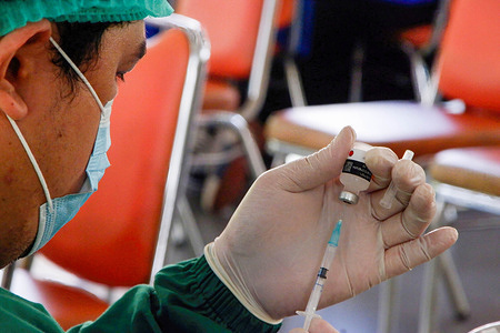 A health worker prepares to administer a dose of the AstraZeneca Covid-19 booster vaccine at a vaccination site in Jakarta.A Covid-19 booster vaccination program is ongoing in Jakarta due to the surge of omicron variant in the last few weeks.