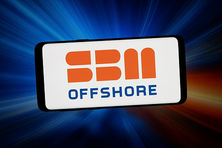 In this photo illustration, the logo of Dutch company SBM Offshore N.V. is seen displayed on a smartphone in front of an abstract background on a computer screen.