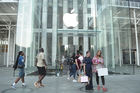 People enter an Apple store on Fifth Avenue in Manhattan, New York City.