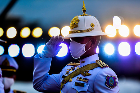 A Thai royal guard pays respect to a portrait of Thai King Maha Vajiralongkorn during the celebration ceremony to mark the 68th birthday at Sanam Luang in Bangkok.