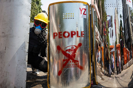 An anti military coup protester stands behind makeshift shields during a demonstration against the military coup.Myanmar police attacked protesters with rubber bullets, live ammunition, tear gas and stun bombs in response to anti military coup protesters on Monday. Two protesters were killed in Myitkyina, Kachin State by the security forces, from local source. A total of 1758 people have been persecuted, 1440 of them still in Myanmar military prisons and 60 people were killed since the beginning of the protests against the military coup. Myanmar's military detained State Counsellor of Myanmar Aung San Suu Kyi on February 01, 2021 and declared a state of emergency while seizing the power in the country for a year after losing the election against the National League for Democracy (NLD).