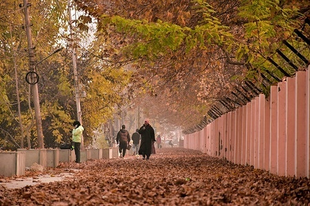 Kashmiri residents walk along the street during a cold autumn day in Srinagar, the summer capital of Jammu and Kashmir.