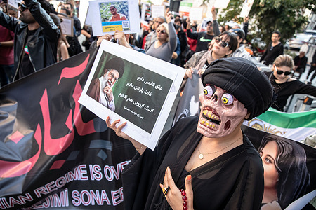 Protesters hold placards expressing their opinion during the demonstration. Protesters organized a demonstration following the death of Mahsa Amini. Mahsa fell into a coma and died after being arrested in Tehran by the morality police for allegedly violating the country's hijab rules. Amini's death has sparked weeks of violent protests across Iran.