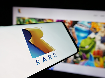 In this photo illustration, a smartphone with the logo of video game development company Rare Limited is seen on screen in front of website.