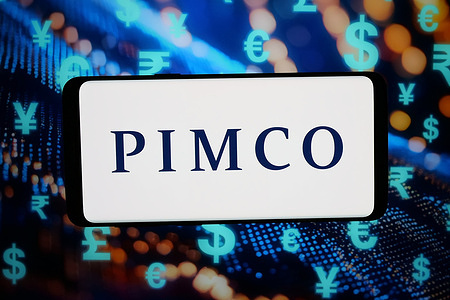 In this photo illustration, the logo of Pacific Investment Management Company (PIMCO) is displayed on a smartphone in front of abstract background on computer screen.
