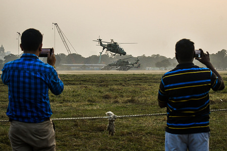 People take photos as the Indian Army personnel with helicopters perform a drill during the rehearsals ahead of Vijay Diwas’s observation. Vijay Diwas is celebrated annually on December 16 to honour the victory of the Indian armed forces over Pakistan in the 1971 Bangladesh Liberation War.