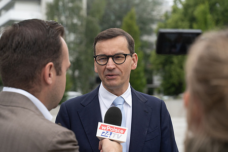 Mateusz Morawiecki seen speaking to journalists during the press conference. The Press conference was held in response to the vote of confidence in Prime Minister Donald Tusk's government taking place in the Polish parliament on the same day. Jarosław Kaczyński and Mariusz Błaszczak criticized the policies of the new administration and expressed concerns over the direction of national governance. The conference reflects the ongoing political rivalry between the opposition PiS and the ruling Civic Coalition.