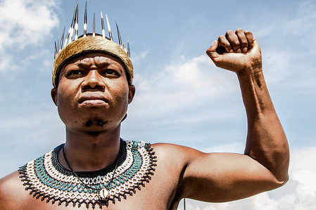 A cultural activist, Thando Mahlangu who was told to leave the mall due to his traditional attire makes a gesture during the protest.Protesters gathered outside the Boulders Shopping Centre in Midrand, South Africa in reaction to a manager who confronted a man dressed in traditional Ndebele attire and asked him to leave a Clicks store in the mall.