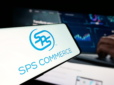 In this photo illustration, a smartphone with the logo of US software company SPS Commerce Inc. is seen on screen in front of website.