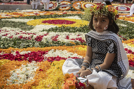A child pays tribute at the Martyr's Monument or Shaheed Minar on International Mother Language Day. International Mother Language Day is observed in commemoration of the movement where a number of students died in 1952 defending the recognition of Bangla as a state language of the former East Pakistan now Bangladesh.