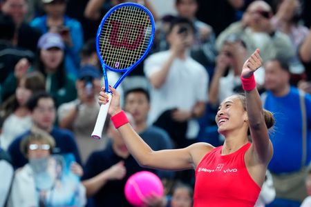 Qinwen Zheng of China celebrates winning against Elise Mertens of Belgium (not in view) during their women's singles semi-final match on day eleven of China Open at the National Tennis Center. Qinwen Zheng defeated Elise Mertens with a score of 7-5, 6-2.
