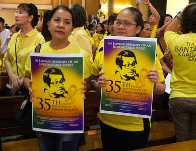 Two women seen holding a Ninoy Aquino's 35th death Anniversary poster.
A Church Mass commemorating the 35th year anniversary of the assassination of Benigno (Ninoy) Aquino Jr. who was assassinated on August 21, 1983 while going down the staircase of a plane at the Manila International Airport.