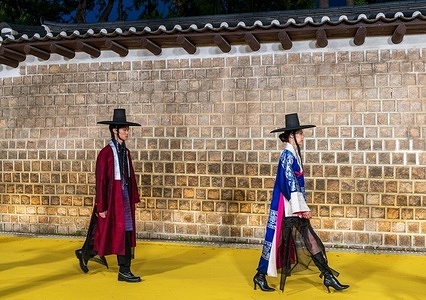 Models walk the runway wearing designer's contemporary hanbok (traditional Korean costume) dress during the 2025 Seoul Fashion Road at Deoksugung Palace Road in Seoul.