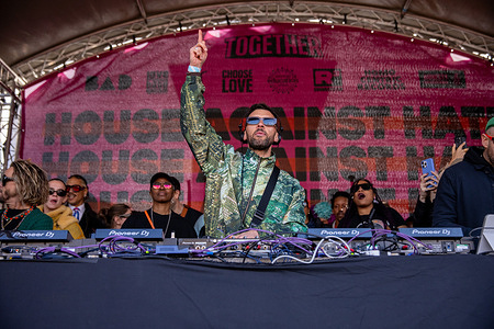 A DJ during a House Against Hate rave in Trafalgar square London. To coincide with an anti–far-right march held in London, organised by the Together Alliance, an outdoor rave was held in Trafalgar Square named House Against Hate. Singers, DJs, and dancers performed on stage in front of a crowd of several thousand to demonstrate against all forms of hatred, division, and discrimination. Organised by the R3 Sound System, this was the third event of its kind to be held over the last seven years.