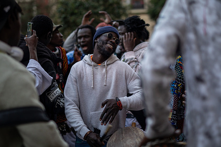 A man celebrates in Lavapiés Square in Madrid. Immigrant groups commemorated in Madrid's Lavapiés square the eighth anniversary of the death of Mame Mbaye, a street vendor who died of a heart attack after a police chase. A large number of the participants in the demonstration then celebrated Iftar (the evening meal that breaks the daily fast during the Islamic month of Ramadan).