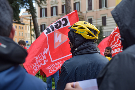A demonstrator holds a placard during the Confederazione Generale Italiana del Lavoro (CGIL) national mobilization for Glovo and Deliveroo riders' rights at Piazza Re di Roma.