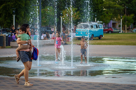 Everything helps when it comes to combating the stifling heat.Children play in a fountain, enjoying the cold water as they cool off on a sweltering day in with temperatures reached 35ºC.