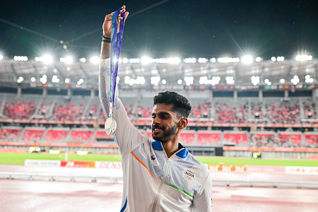Indian long jumper Murali Sreeshankar poses with his silver medal at the Asian Games 2026 in Nagoya. Gold medal: Shi Yuhao (China) — 8.17 m, Silver medal: Murali Sreeshankar (India) — 8.07 m, Bronze medal: Anvar Anvarov (Uzbekistan) — 8.06 m