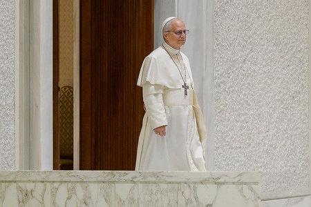 Pope Leo XIV arrives for a meeting with the press in the Paul VI Hall.