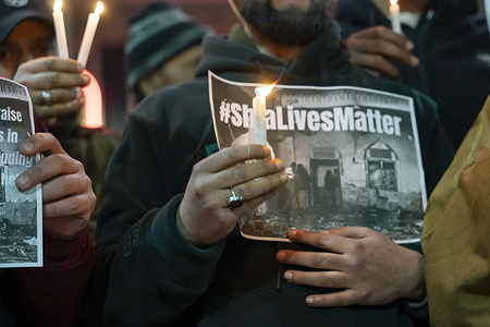 A Shia Muslim man holds a candle and a poster reading “Shia Lives Matters” during a protest denouncing the suicide attack on a mosque that killed 31 people. Shia Muslims in Srinagar staged protests over the killings in Pakistan following the suicide bombing at a Shia mosque in Islamabad that left at least 31 people dead.