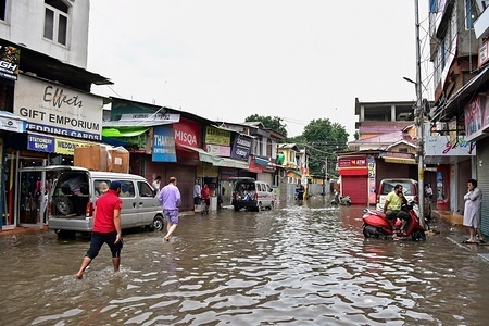 Residents wade after the heavy rains in Srinagar.
Rains caused water-logging in many areas of Srinagar exposing the poor drainage system of the city. The weather department has predicted heavy rainfall for next few days all over the region.