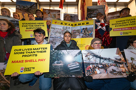 Protesters hold photos of the damage caused by Typhoon Odette. Protesters held a vigil outside Shell Centre in London to mark the anniversary of Typhoon Odette, which killed hundreds and destroyed more than a million homes in the Philippines. Organized by a coalition including Greenpeace Philippines, the Philippines Movement for Climate Justice, the International Coalition for Human Rights in the Philippines, Uplift, and Fossil Free London, the event brought together activists and members of the Filipino community. Participants demanded accountability from Shell and expressed solidarity with communities most affected by the climate crisis.