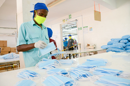 NAIROBI, KENYA - APRIL 13, 2020:
An employee at Shona EPZ Limited packing already-made face masks.
The company is one of the main producers of face masks and PPEs in the country with nearly 300 employees who manufacture more than 20,000 face masks daily that are distributed countrywide in order to help curb the spread of the coronavirus. Kenya has so far recorded 208 cases of the coronavirus, 22 recoveries and 9 deaths.