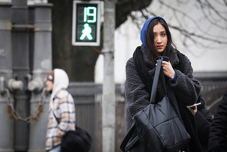 A girl seen walking across a pedestrian crossing.