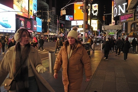 People walk in Times Square, Manhattan, New York City.