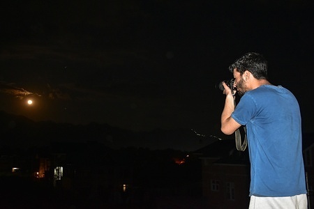 A man photographs the full flower moon in Srinagar, the summer capital of Jammu and Kashmir. The name 'Flower Moon' originates from Native American and European traditions to mark the peak of spring blooming flowers. Symbolizing fertility, growth and renewal. The 'Flower Moon' is also known as a 'micromoon', because the Moon is at its furthest point from Earth, and look smaller than usual.