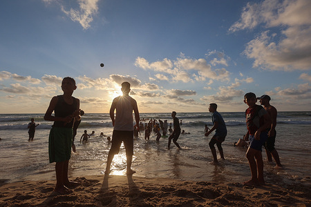 Palestinians play football at the Mediterranean Sea beach on the second day of Eid al-Adha holiday.