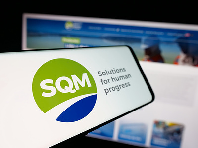 In this photo illustration, a smartphone with the logo of Sociedad Quimica y Minera de Chile (SQM) is seen on screen in front of website.