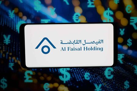 In this photo illustration, the logo of Qatari company Al Faisal Holding is displayed on a smartphone in front of abstract background on computer screen.
