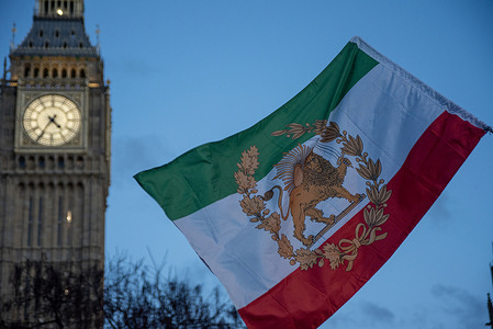 A Iranian royalist flag flies front of the Big Ben during the demonstration. A small group of Iranian royalists gathered outside the Parliament in London, UK. Protesters want to show their support to the anti-government protesters in Iran. Demonstrators intend to replace the Supreme Leader of Iran, Ayatollah Ali Khamenei and his regime to the Crown Prince of Iran, Reza Pahlavi who lives in exile at the United States.