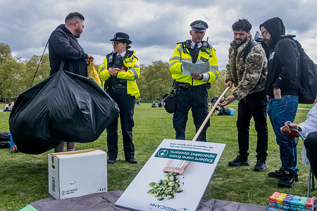 Police seen questioning people holding large bags and signs of advocating for medical cannabis use in Hyde Park.