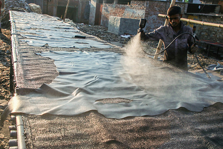 A worker sprays coloured chemical on a piece of leather at a tannery in Dhaka.
The Leather industry is a major industry in Bangladesh and the Government of Bangladesh has declared it as a priority sector. The industry was the second largest export sector of Bangladesh. The industry also plays a good role in creating employment. Human Right Watch reported that it is responsible for pollution of air, water, and soil that led to serious health problems in the population.