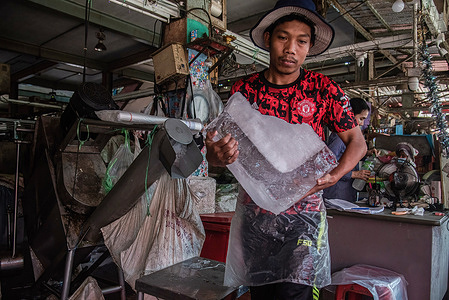 A worker seen carrying a block of ice at a Khlong Toei market during a hot weather day in Bangkok. Thai authorities have warned people to avoid outdoor activities as the country experiences a heatwave, with temperatures soaring to record highs of over 44 degrees Celsius in some areas.