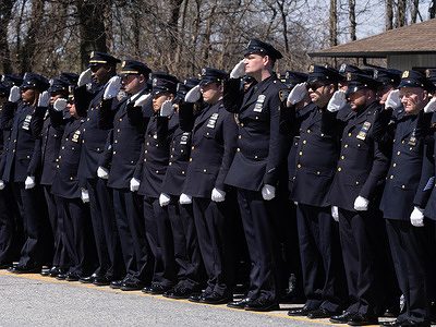 NYPD officers salute as the hearse passes by. Funeral for fallen NYPD Officer Jonathan Diller was held with hundreds of police n officers lined up in front of the St. Rosa of Lima Toman Catholic Church. According to police reports, Officer Diller, aged 31, and his partner were performing a traffic stop for an illegally parked car in Far Rockaway. During the encounter, an individual in the vehicle brandished a firearm and aimed it at the officers, prompting an exchange of gunfire. Tragically, Officer Diller sustained a gunshot wound to the torso below his bullet-resistant vest and was swiftly transported to a nearby hospital. Despite efforts, he succumbed to his injuries shortly thereafter.