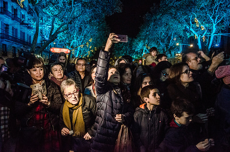 A group of people waiting to see the Christmas lights. Barcelona turned on the lights of Christmas 2017. The lighting ceremony has been presided over by the Mayor of Barcelona Ada Colau and representatives of institutions of trade of the city. After the performances of dance and singing the Mayor Ada Colau has connected a large plug featuring the lighting of the Christmas lights.