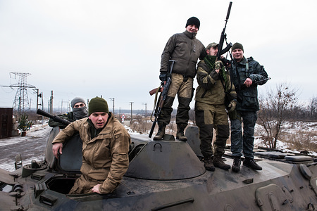 Soldiers of the Donbass Battalion seen standing on top of one of their APCs.