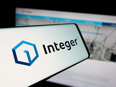 In this photo illustration, a smartphone with the logo of US company Integer Holdings Corporation is seen on screen in front of website.