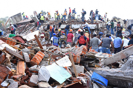 Rescue workers seen trying to search for survivors in one of the collapsed buildings. Volunteers continue with rescue work for the second day after the 7.1 magnitude earthquake occurred, at least 225 people has confirmed dead.