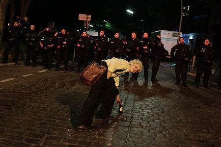 A protester drinks beer in front of police officers during the “Revolutionary May Day” demonstration in the Kreuzberg and Neukölln districts of Berlin. People took part in the rally, with protesters chanting slogans against NATO, capitalism and war, as well as expressing solidarity with Palestine and several other countries. According to authorities, around 50,000 people participated in May Day events across Berlin, including about 10,000 in the evening march. Police deployed roughly 5,000 officers, and no major clashes were reported. Traffic restrictions were introduced in several areas, and some metro stations were temporarily closed due to large crowds.
