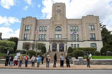 Protesters gather during the demonstration. People gathered outside Hazleton City Hall for an "ICE Out" protest. Demonstrators opposed the city council's decision to join the Task Force 287(g) program, which allows local police to collaborate directly with U.S. Immigration and Customs Enforcement (ICE).
