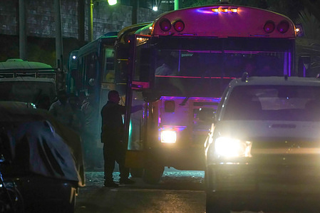 A prison warden enters a bus at the La Esperanza Penitentiary Center as a convoy transporting prisoners leaves on its way to the CECOT (Terrorism Confinement Center prison complex) Some 2000 inmates were transported from multiple penitentiary centers to the new terrorist condiment center inaugurated in February of 2023 the Salvadoran government reported.