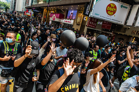 Protesters show out their palms, symbolising the five demands during the demonstration.
Entering the 18th week of civil unrest, protesters marched on the morning of China's National Day, which celebrates the 70th anniversary of People's Republic of China this year. Demonstrators chanted slogans and continued to ask for the five demands to be met. Protesters clashed with riot police and were hit with tear gas, rubber bullets, and water cannons and eventually many were arrested.